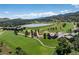 Stunning aerial view of a golf course community with a lake and mountain views at 16226 River Haven Way, Morrison, CO 80465