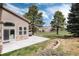 Landscaped backyard featuring a patio and manicured lawn, perfect for outdoor activities at 16226 River Haven Way, Morrison, CO 80465