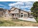 Expansive backyard featuring a patio, hot tub, stone accents, and a well-maintained lawn at 16226 River Haven Way, Morrison, CO 80465