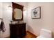Powder room with dark wooden vanity, hard wood floors and painted walls at 16226 River Haven Way, Morrison, CO 80465