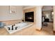 Elegant bathroom boasting a soaking tub and a fireplace at 16226 River Haven Way, Morrison, CO 80465