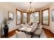 Charming dining room features a wooden table set for six, a vintage chandelier, and natural light at 16226 River Haven Way, Morrison, CO 80465