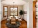 Bright dining room features a round table, hardwood floors, and a large window with natural light at 16226 River Haven Way, Morrison, CO 80465