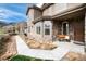 Inviting exterior with stone accents, large windows, and a cozy front porch, offering curb appeal and mountain views at 16226 River Haven Way, Morrison, CO 80465