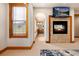 Hallway with a view of fireplace and TV and a view into main bathroom at 16226 River Haven Way, Morrison, CO 80465