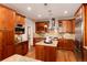Spacious kitchen offering wood cabinetry, a center island, and modern appliances at 16226 River Haven Way, Morrison, CO 80465