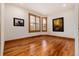 Spacious living room with hardwood floors, large windows, and decorative art pieces at 16226 River Haven Way, Morrison, CO 80465