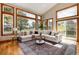 Bright living room featuring large windows, a comfortable sectional, and stylish decor at 16226 River Haven Way, Morrison, CO 80465
