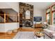 Cozy living room highlights a stone fireplace, built-in bookshelves, and modern furnishings at 16226 River Haven Way, Morrison, CO 80465