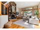 Cozy living room featuring a stone fireplace, large windows, and comfortable seating, creating an inviting atmosphere at 16226 River Haven Way, Morrison, CO 80465