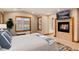 A bright main bedroom features a fireplace, large window, and hardwood trim at 16226 River Haven Way, Morrison, CO 80465