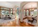 Spacious living area flows to dining room with abundant natural light and hardwood floors at 16226 River Haven Way, Morrison, CO 80465