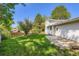 A fenced backyard featuring a grassy area and a concrete patio at 7542 Otis St, Arvada, CO 80003