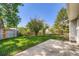 A fenced backyard featuring a grassy area and a concrete patio at 7542 Otis St, Arvada, CO 80003