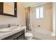 Bathroom featuring a vanity, mirror, shower, and toilet at 7542 Otis St, Arvada, CO 80003