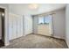 Bedroom featuring carpet, closet, and window at 7542 Otis St, Arvada, CO 80003