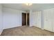 Bedroom featuring carpet, closet, and door at 7542 Otis St, Arvada, CO 80003