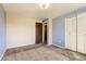 Bedroom featuring carpet, closet, and door at 7542 Otis St, Arvada, CO 80003