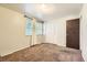 Neutral bedroom featuring a window, carpet, and closet with panel doors at 7542 Otis St, Arvada, CO 80003