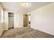 Bedroom featuring carpet, closet, and doorway to another room at 7542 Otis St, Arvada, CO 80003