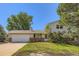 Charming two-story home with a two-car garage and mature trees in a residential neighborhood at 7542 Otis St, Arvada, CO 80003