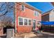Back of house with patio, small garden, and stairs to the back door at 2983 Fulton St, Denver, CO 80238