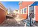 Charming backyard with stone patio, stairs to entrance and wood fence at 2983 Fulton St, Denver, CO 80238