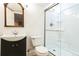 Updated bathroom features a vanity, toilet, frameless shower, and large mirror at 2983 Fulton St, Denver, CO 80238