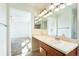 Bathroom with a vanity, decorative lighting, and a view into the bedroom at 2983 Fulton St, Denver, CO 80238
