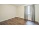 Bedroom with wood floors, neutral walls, and a window with curtains at 2983 Fulton St, Denver, CO 80238