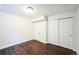 Bedroom with wood floors, standard closet and door to hallway at 2983 Fulton St, Denver, CO 80238