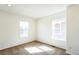 Bedroom featuring neutral carpet, base molding, two windows, and electrical outlets at 2983 Fulton St, Denver, CO 80238
