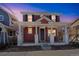 Charming two-story home features a welcoming front porch with stately white columns at 2983 Fulton St, Denver, CO 80238