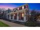 Two story home with inviting front porch supported by white pillars at 2983 Fulton St, Denver, CO 80238