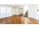 Open living area with hardwood floors, stairs, and windows at 2983 Fulton St, Denver, CO 80238