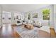 Bright and open living room with hardwood floors, large windows, and neutral decor at 2983 Fulton St, Denver, CO 80238