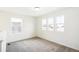 Bright bedroom with three windows, soft carpet, and white walls, providing a serene, light-filled space at 13402 E 110Th Way, Commerce City, CO 80022