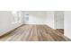Open floor plan featuring wood flooring, large window and a white door at 13402 E 110Th Way, Commerce City, CO 80022