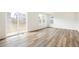 Bright living area features wood flooring, large windows, and sliding glass door at 13402 E 110Th Way, Commerce City, CO 80022