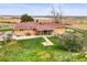 Aerial view of a home with a well-manicured lawn, patio, and countryside views, ideal for peaceful living at 12101 Riverdale Rd, Brighton, CO 80602