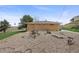 Backyard view of the brick house with rustic decor and a vast landscape at 12101 Riverdale Rd, Brighton, CO 80602