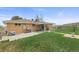 Brick house showcasing a large yard, patio, and fence at 12101 Riverdale Rd, Brighton, CO 80602