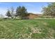 Exterior of a two-story brick house showcasing its spacious lawn and landscape at 12101 Riverdale Rd, Brighton, CO 80602