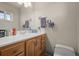 Bathroom featuring a vanity, a sink with a mirror, and a toilet at 12101 Riverdale Rd, Brighton, CO 80602