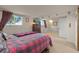 Spacious bedroom with natural light, carpet, and a TV at 12101 Riverdale Rd, Brighton, CO 80602