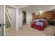 Bedroom featuring a decorative wall accent and carpeting throughout at 12101 Riverdale Rd, Brighton, CO 80602