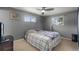 Neutral bedroom with a comfortable bed, windows, and a ceiling fan for added comfort at 12101 Riverdale Rd, Brighton, CO 80602