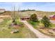 Charming ranch-style home with a long driveway and well-maintained lawn and mature trees at 12101 Riverdale Rd, Brighton, CO 80602