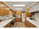 Classic kitchen with wood cabinets, modern appliances, and an efficient layout at 12101 Riverdale Rd, Brighton, CO 80602