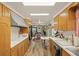 Well-lit kitchen featuring warm wood cabinetry, white countertops, and appliances at 12101 Riverdale Rd, Brighton, CO 80602